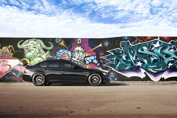 Black BMW on a graffiti wall background