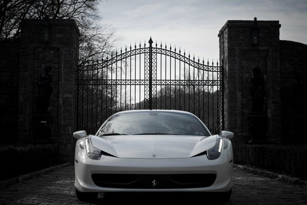 On a black and white background is a gorgeous Ferrari