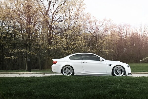 White BMW e92 car on the road in autumn