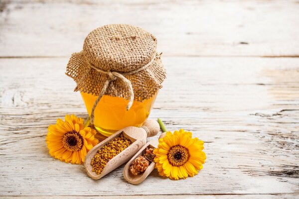 A jar of honey with flowers