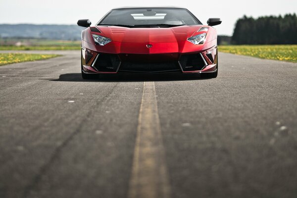 A red Lamborghini on an asphalt road