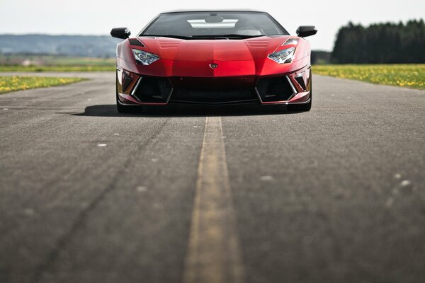 Lamborghini rosso sulla strada asfaltata