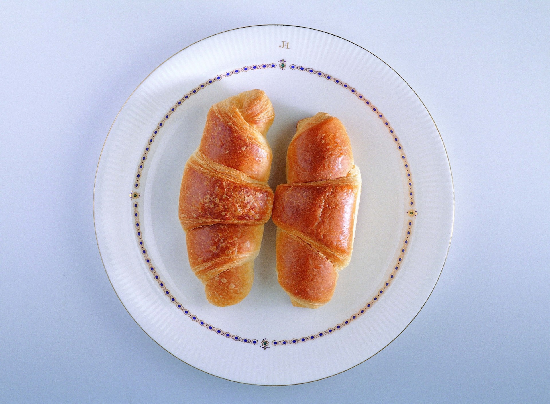 blue background croissant plate