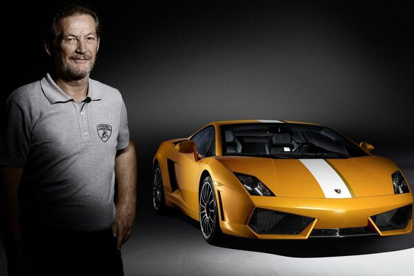 A man in a grey polo shirt and a yellow car