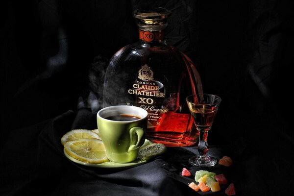 Coffee with cognac and lemon on a dark background