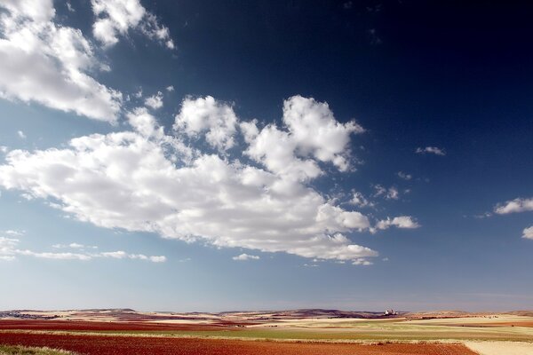 Fluffy clouds on the background of a deserted plain