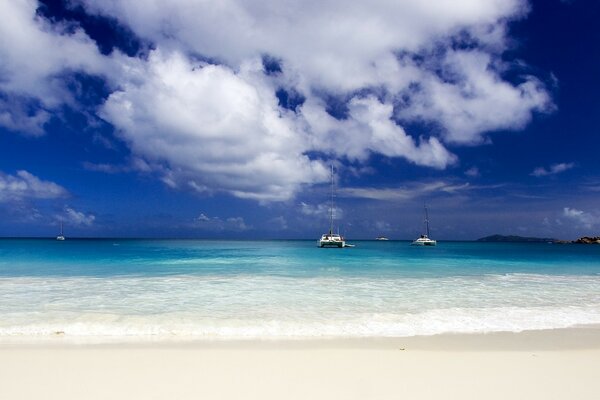 Blue sky over the ocean with sand