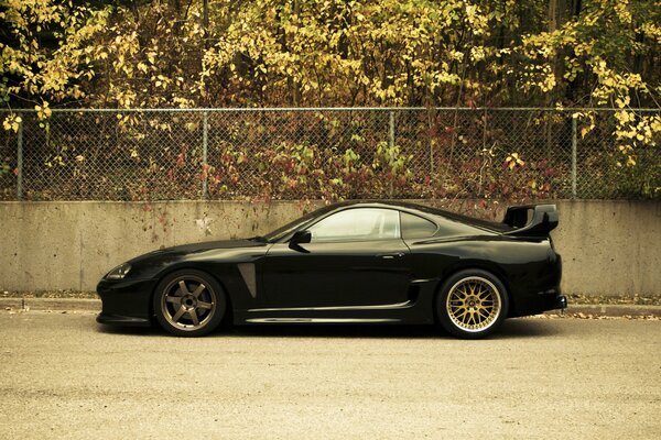 Luxury toyota supra cars on the background of the autumn city