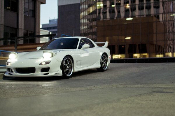 White car in the city parking lot