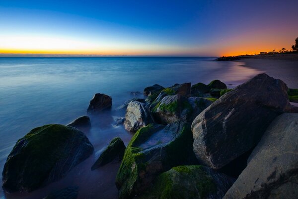 Big stones on the sand in the evening