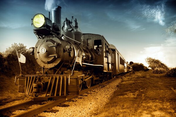 Retro-Dampflokomotive auf Schienen, mit eingeschaltetem Scheinwerfer