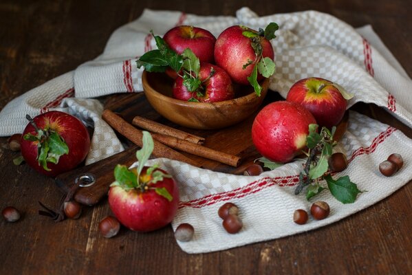 Apples nuts and cinnamon on a towel