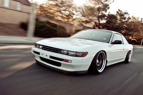 White Nissan Sylvia S13 on the move through the city