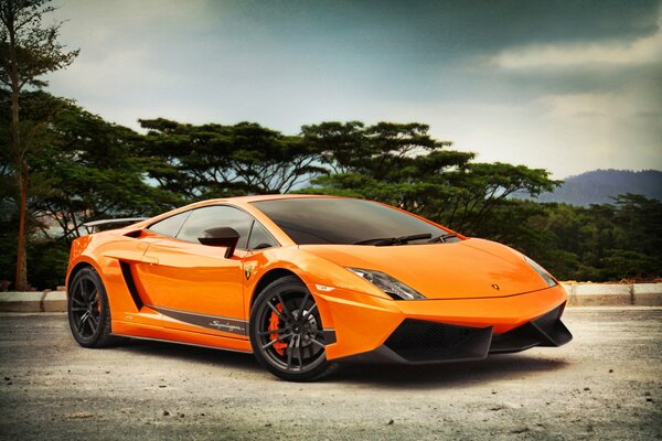 Orange Lamborghini with black wheels