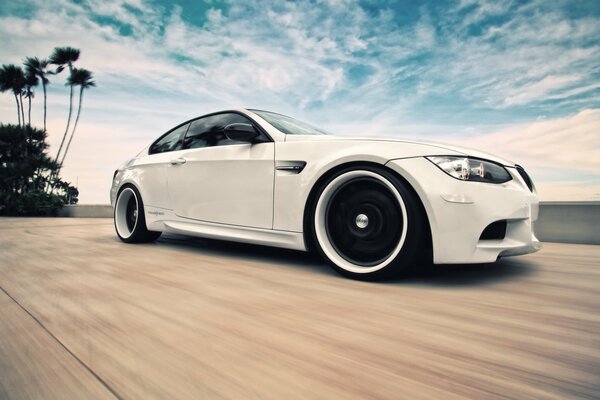 White BMW on a cloudy sky background