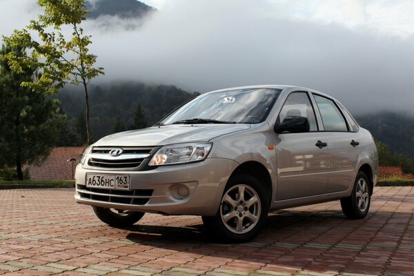 Lada Granta gray on the background of mountains