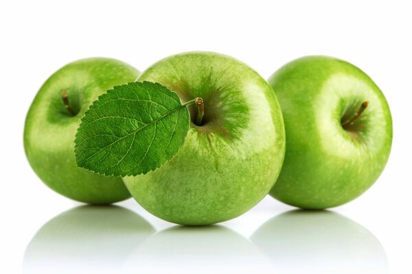 White background green apples with a leaf