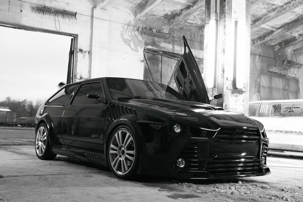 Black Lada on the background of a destroyed building