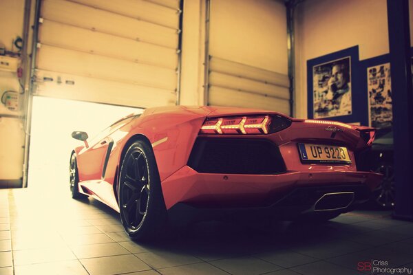 Rear view of a Lamborghini leaving the garage