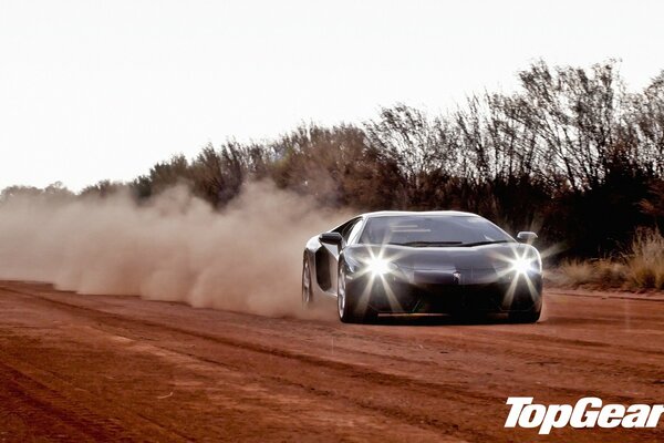 The famous supercar on a dusty road