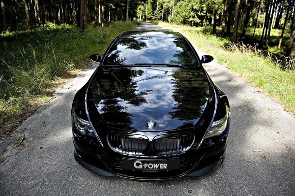 A beautiful black car is standing on the road