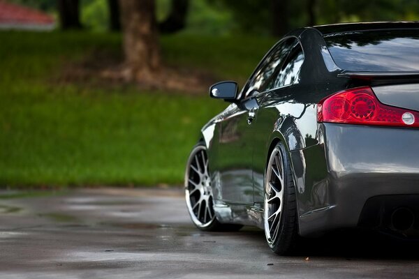 The car is standing on wet asphalt