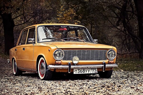 Lada amarilla del primer modelo en el parque de otoño