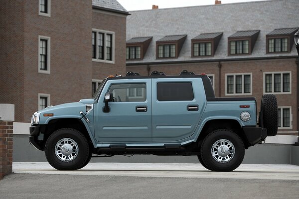 Photo of a hummer car on the background of neat houses