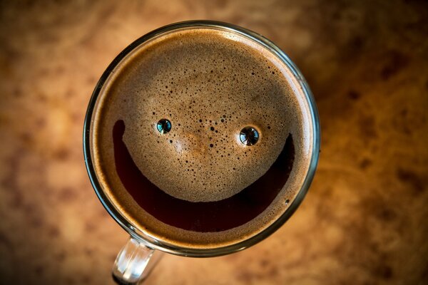 Caffè positivo con schiuma sorridente