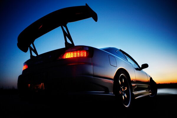 Rear high spoiler, Nissan, headlights, sunset reflection