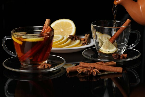 Two cups of tea with lemon and cinnamon