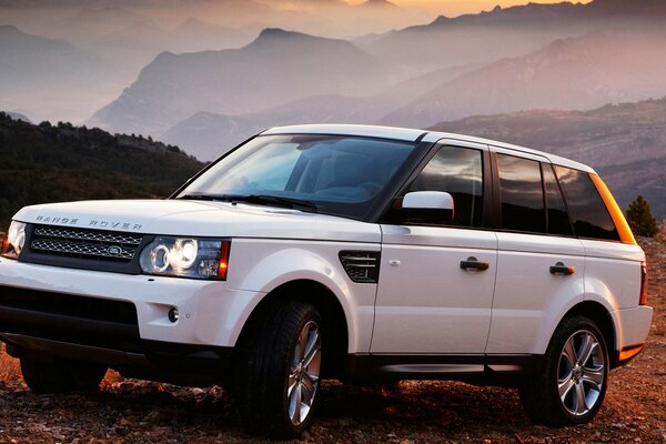 Jeep bianca elegante range rover al tramonto in montagna