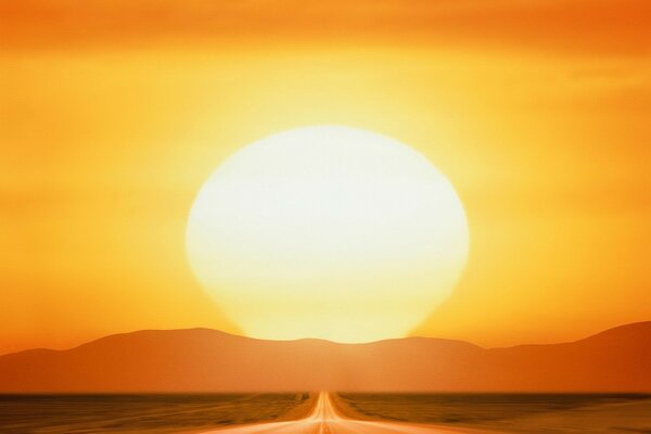 A long road on the background of sunset