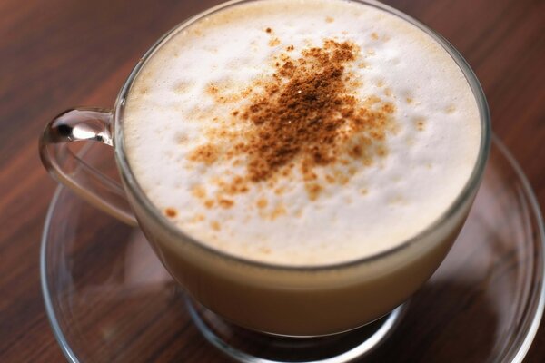 Coffee in a mug with cinnamon and foam