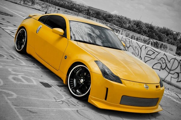 Bright yellow Nissan in a sports body kit