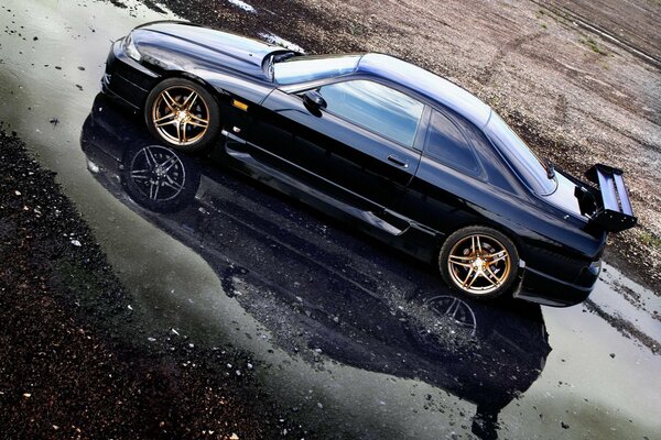 Nissan GTR R33 on a wet road