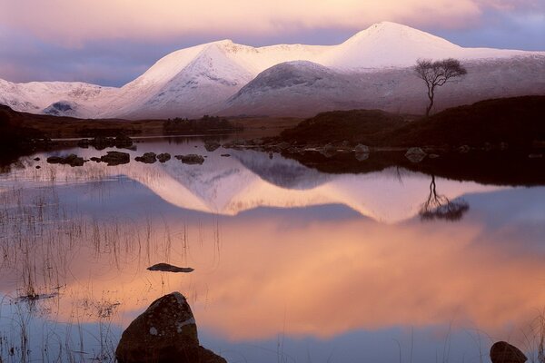 A mountain of snow on the background of sunset