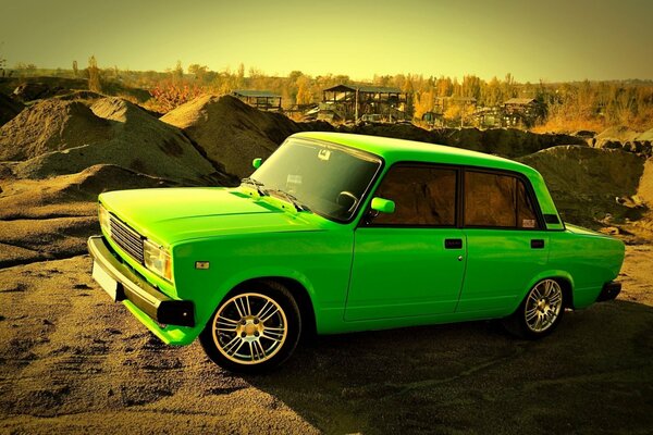 The green Lada among the sand quarry
