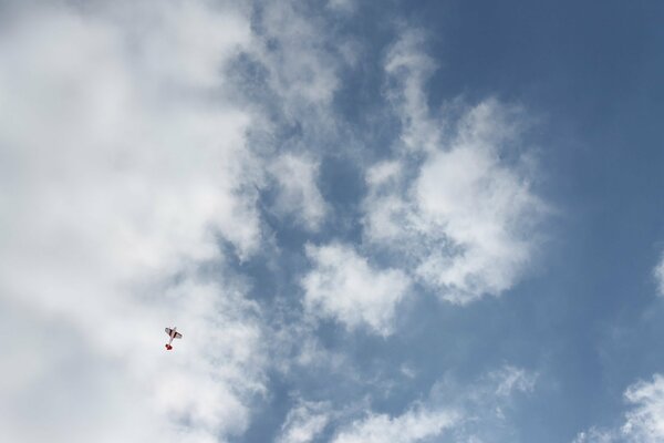 Avion sur fond de nuages blancs et le ciel bleu