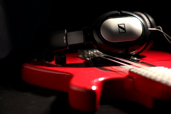 Still life headphones and red guitar