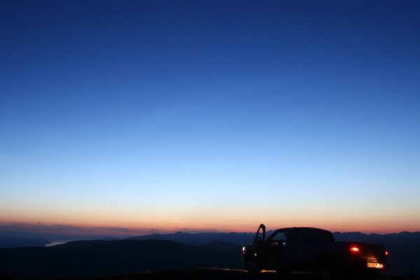 A lonely car on the background of the night sky