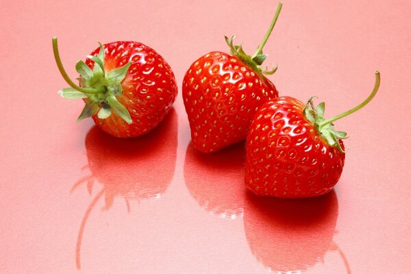 Juicy strawberry on a pink background