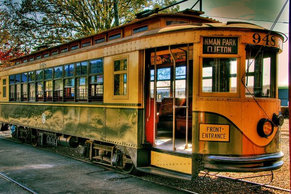 Green retro tram on rails