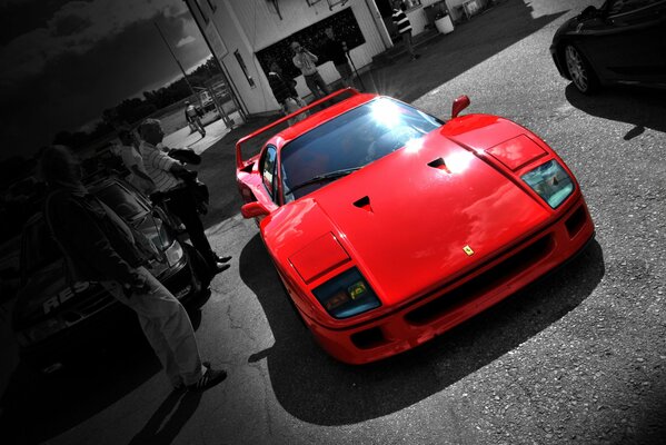 Red ferrari f40 on a black and gray background