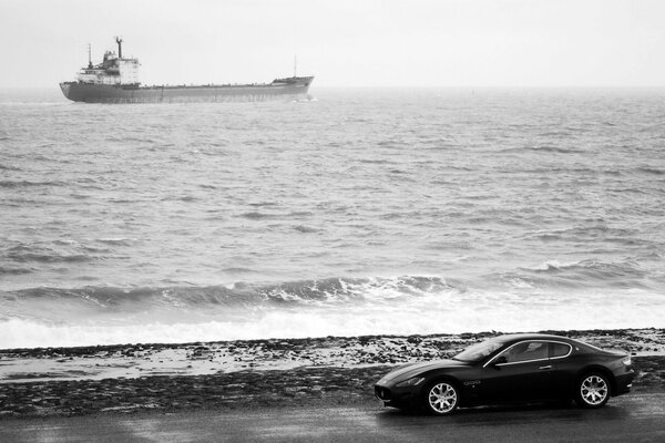 Photo of a black maserati on the coast