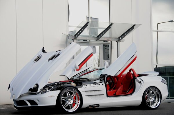 Mercedes is white with open doors and hood