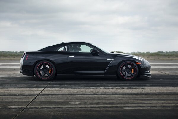 Black Nissan car on the road