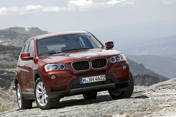 Red BMW on the rocks with a beautiful view for you