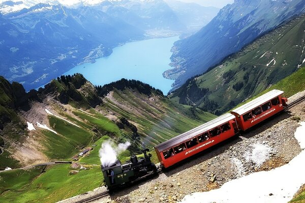 The locomotive goes in the mountains past the lake