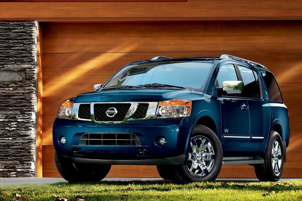 Nissan Armada with beautiful discs is standing in a cozy courtyard near the garage